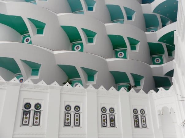 White and sea-green balconies stacked up the atrium
