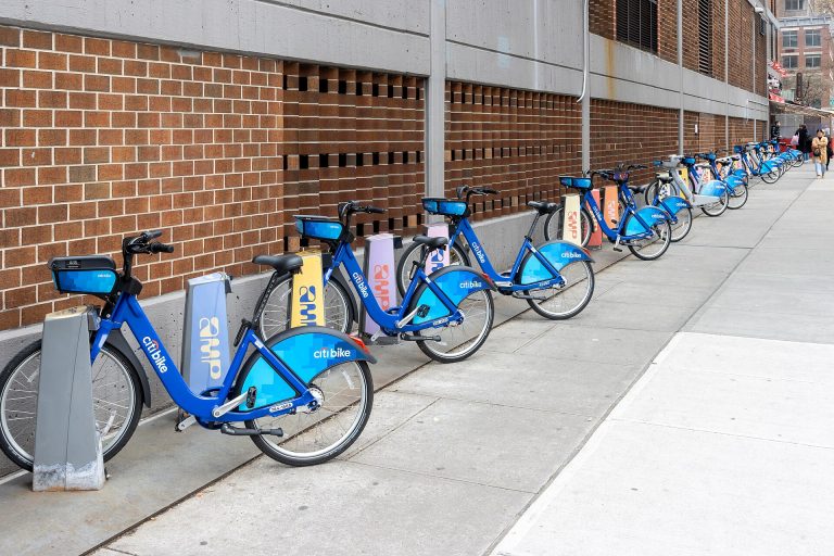 Citi Bike docking station along a tree-lined Manhattan street