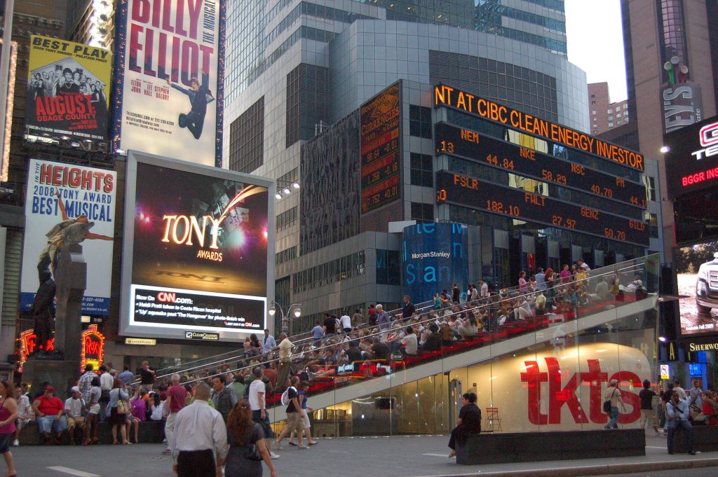 The glowing red glass steps above the TKTS discount Broadway booth at Father Duffy Square (47th St & Broadway) β Midtown West Budget Hotels Near Times Square